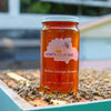 Raw local Florida orange blossom honey from How's Your Day Honey in St. Petersburg FL, one 24oz jar. Photographed on a hive of honey bees.
