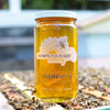 Raw local gallberry honey from How's Your Day Honey in St. Petersburg FL, one 24oz jar. Photographed on a hive of honey bees.